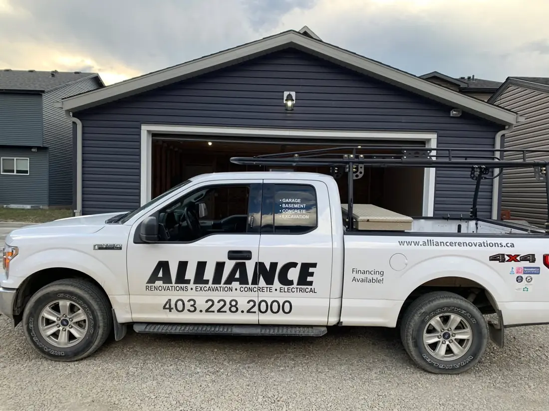 Alliance Renovations truck parked in front of a navy garage
