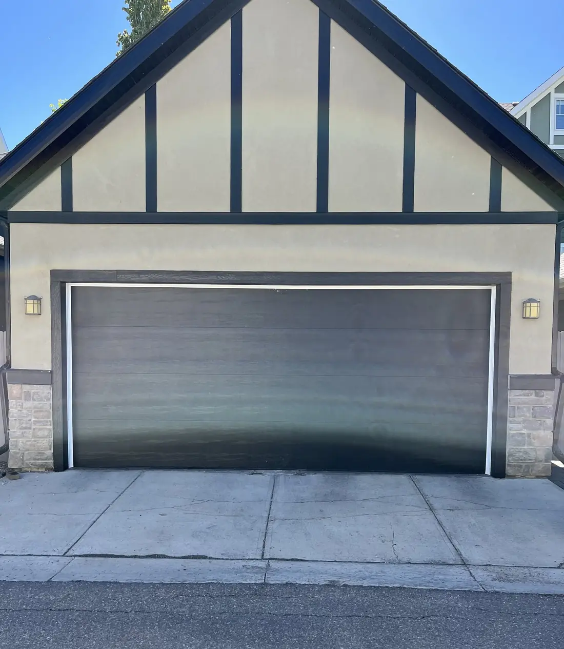 After: one wide flush garage door with a wood-grain finish