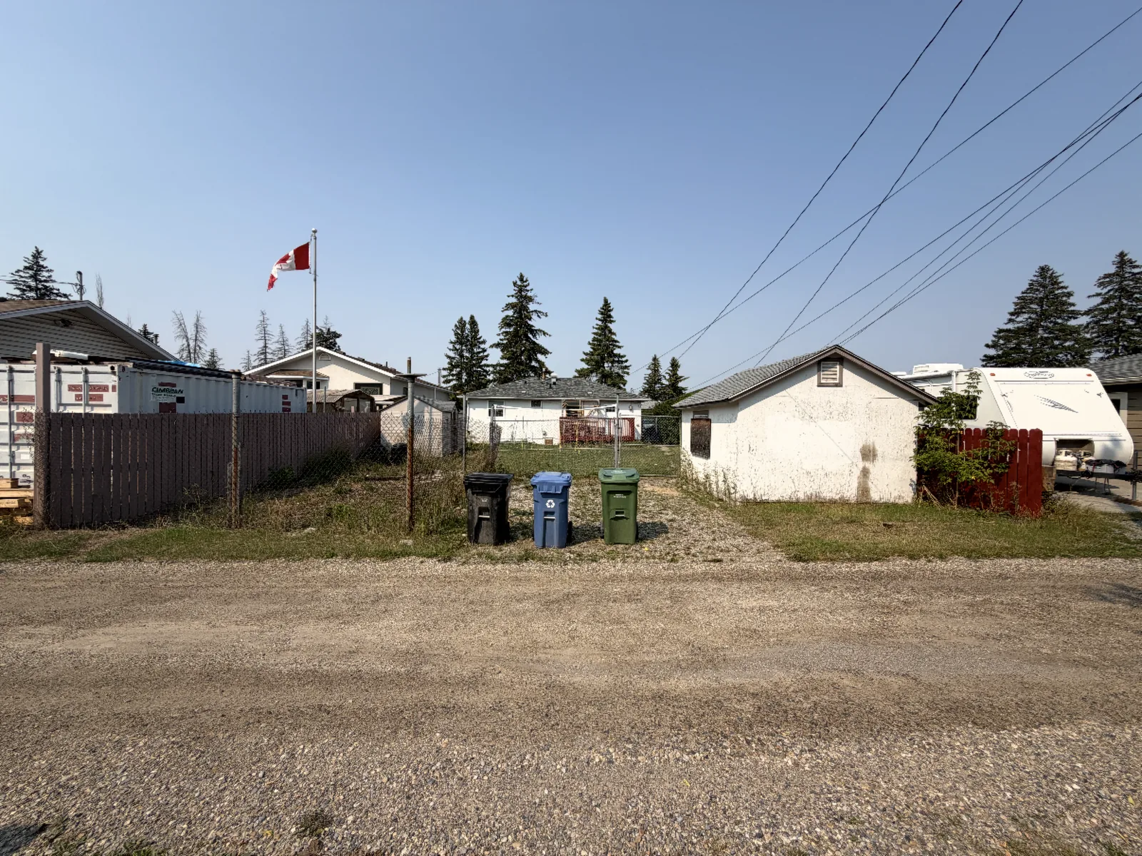 Before: an open lot off the back lane, seen from the same spot