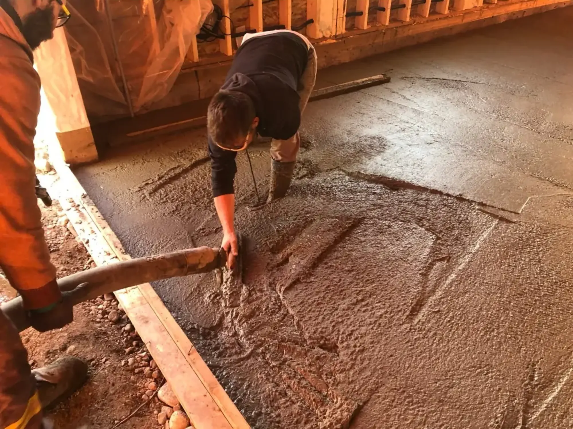 An Alliance crew member finishing a fresh concrete slab