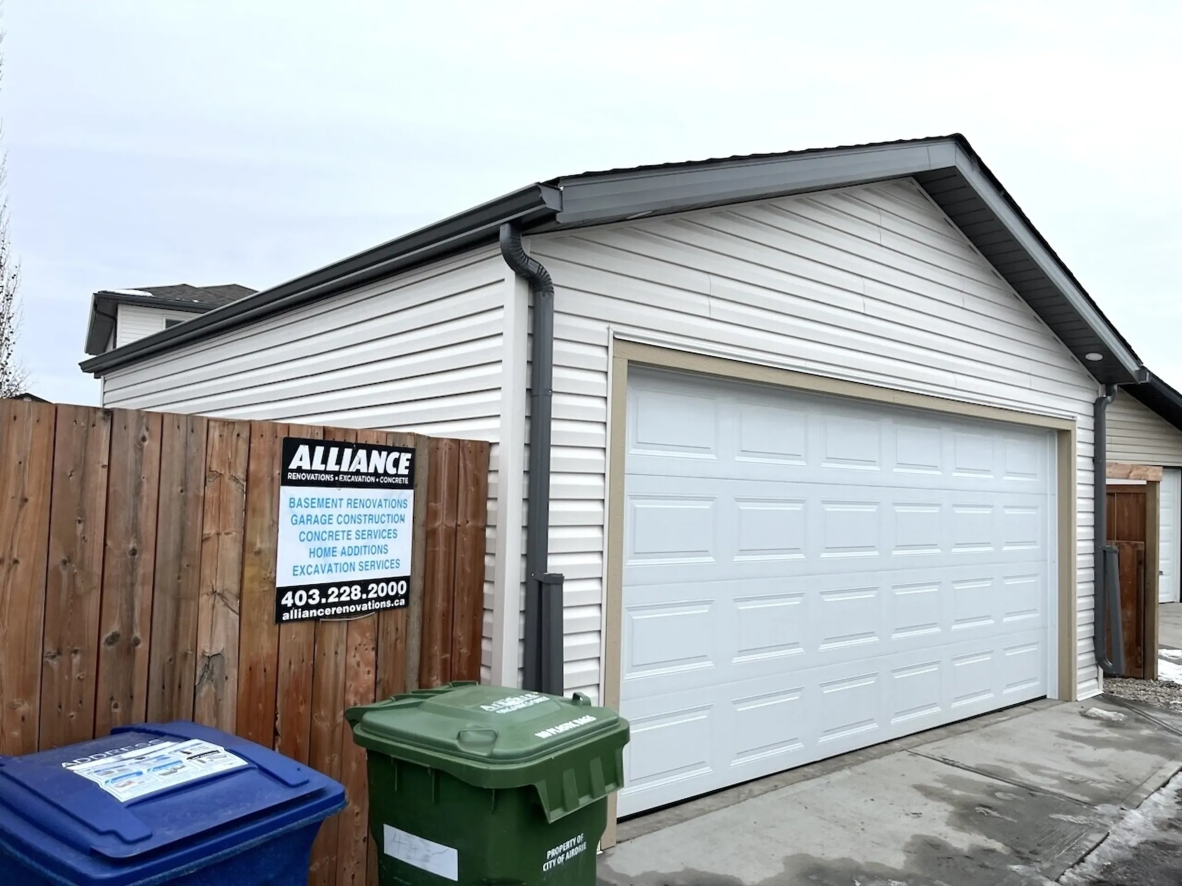 A new garage in Airdrie with an Alliance site sign on the fence