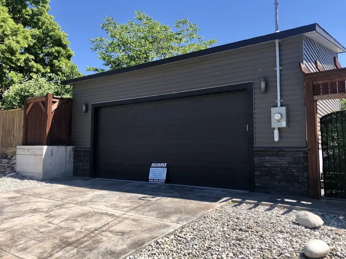 Driftwood siding, stone base, a garage built by Alliance Renovations